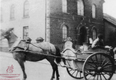 A milk delivery by horse and cart c.1910 